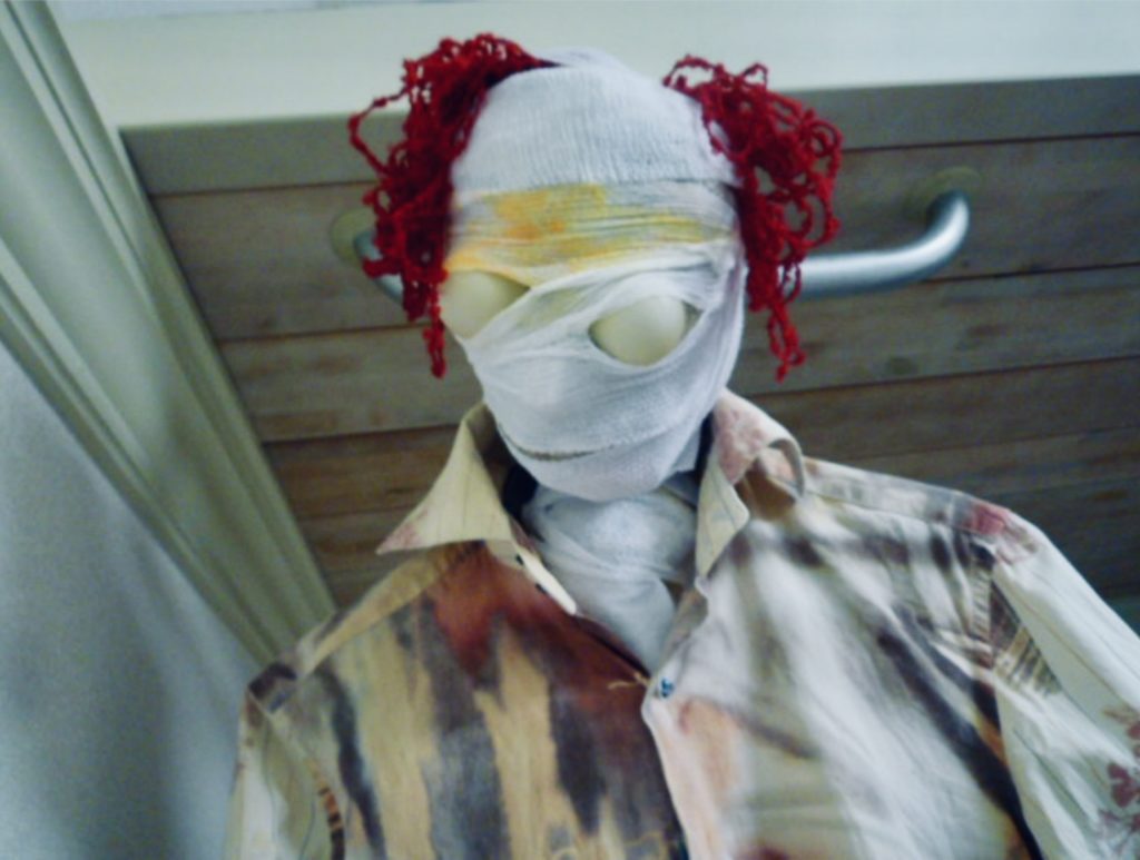 頭に包帯を巻き赤い毛糸をつけた人形、ハロウィン